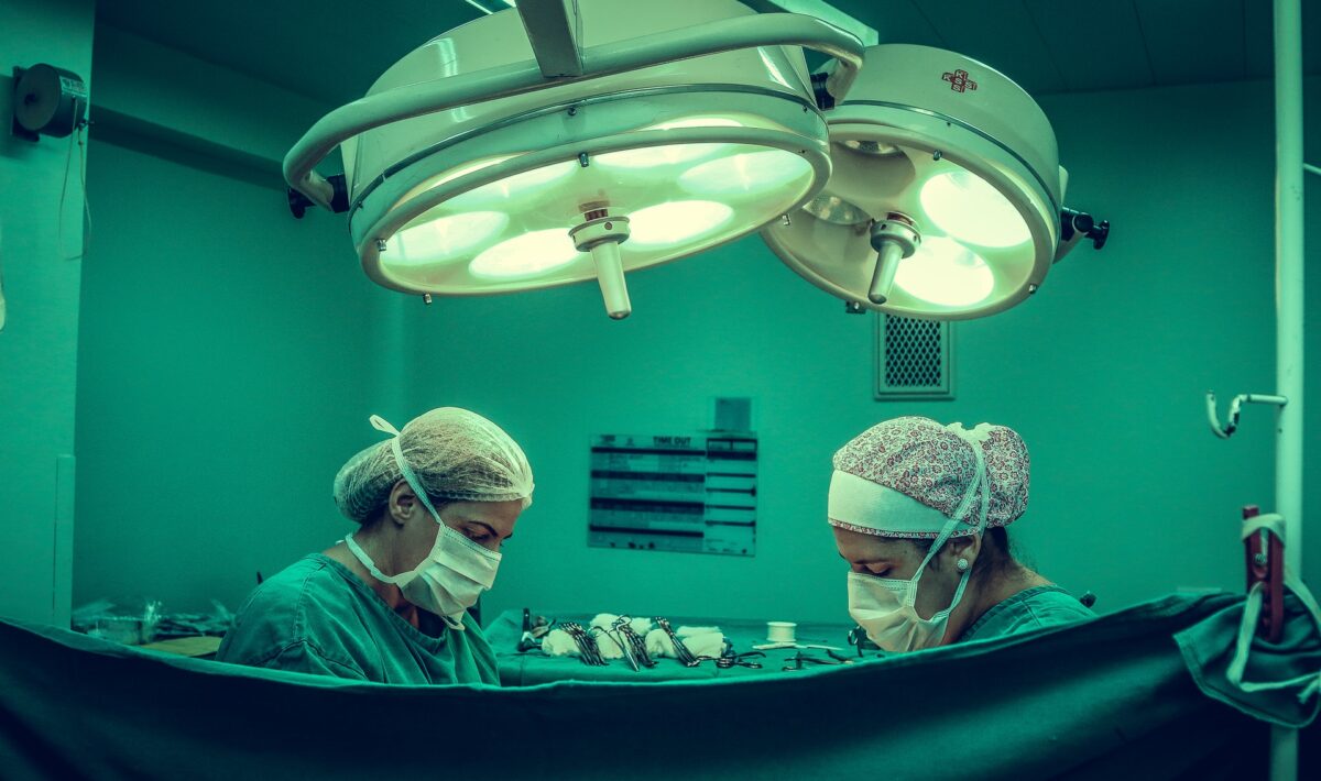 /two-person-doing-surgery-inside-room